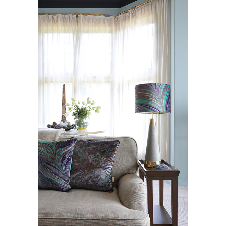 Grey and blue velvet cushion on neutral sofa with matching lampshade