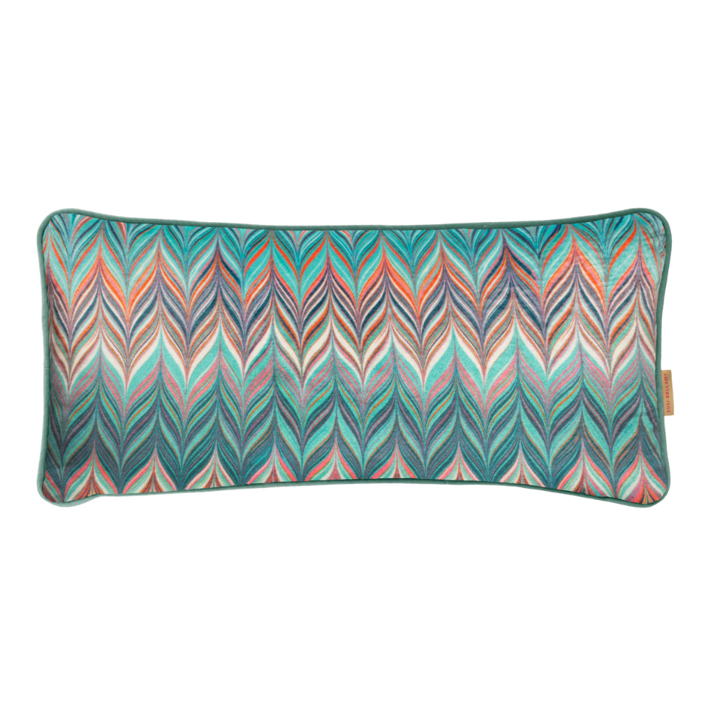 A rectangular lumbar pillow featuring a vibrant, multicolored chevron pattern with teal, orange, pink, and blue stripes, finished with a solid teal border and a small tan brand tag on the right edge.