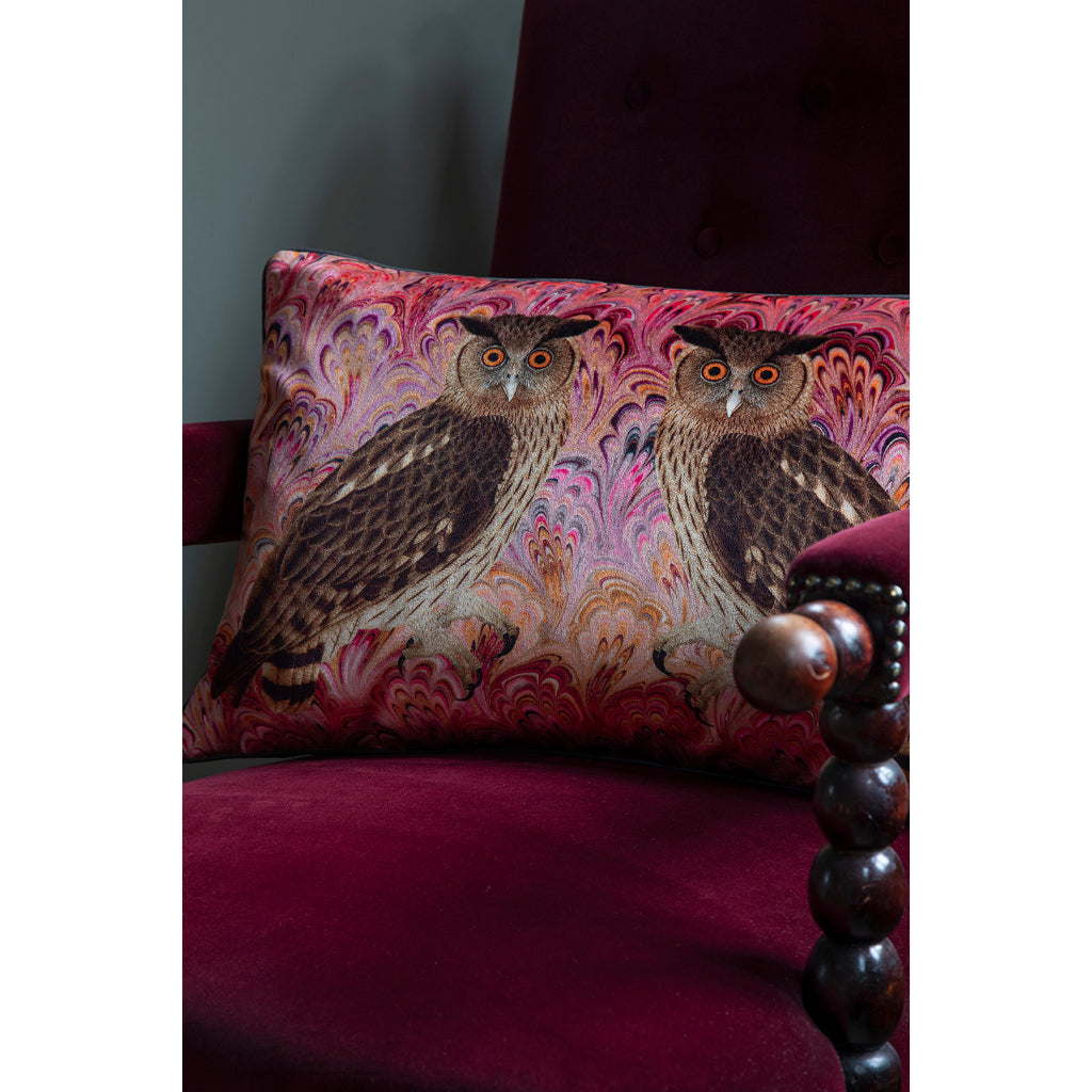 Decorative pillow with owl design on a purple chair