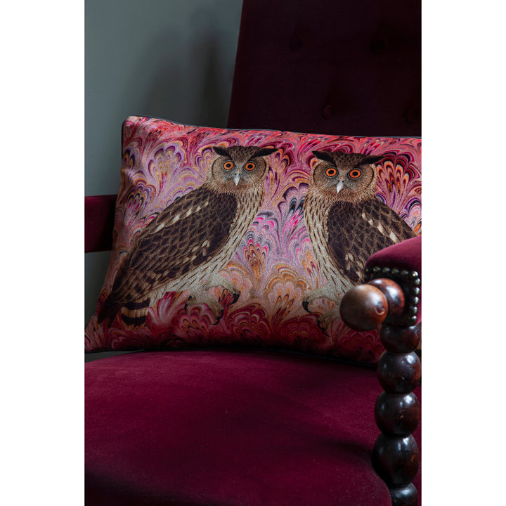 Decorative pillow with owl design on a purple chair