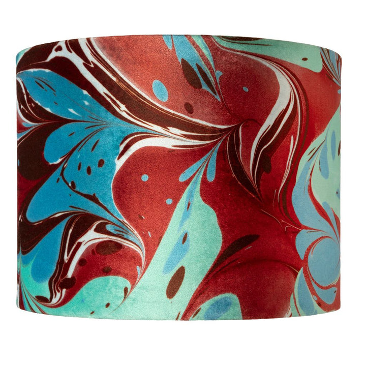 A drum lampshade featuring a vibrant marbled pattern with swirls of red, turquoise blue, mint green, and dark brown on a white background.