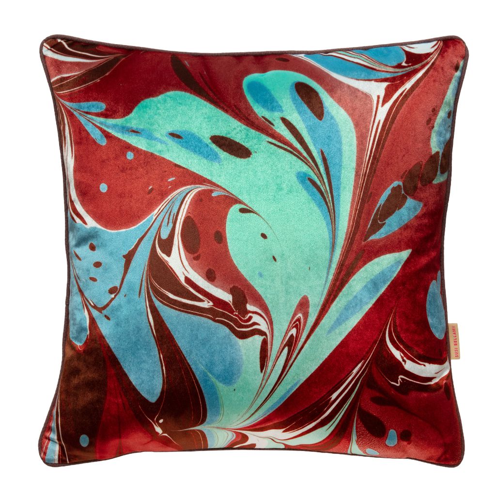 A square throw pillow featuring an abstract marbled pattern in deep red, turquoise blue, white, and dark brown, set against a plain white background.