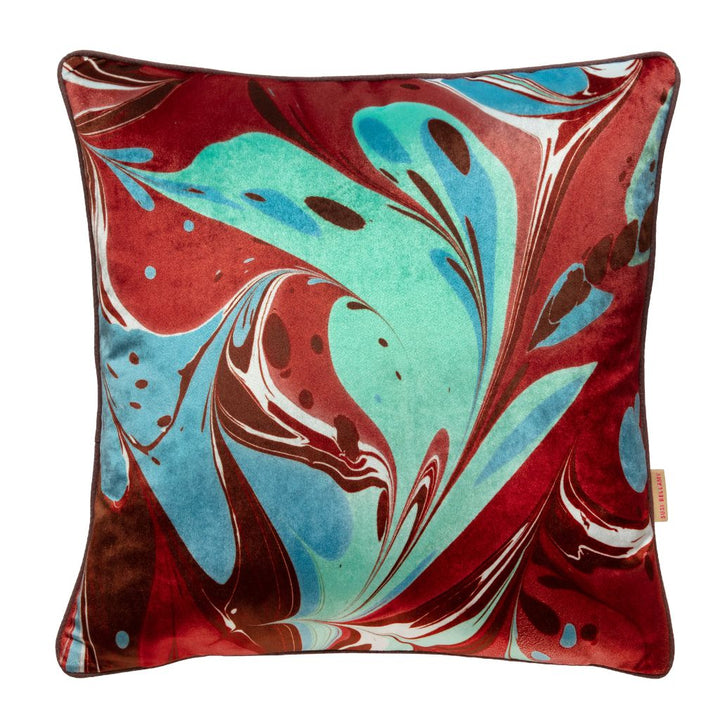 A square throw pillow featuring an abstract marbled pattern in deep red, turquoise blue, white, and dark brown, set against a plain white background.