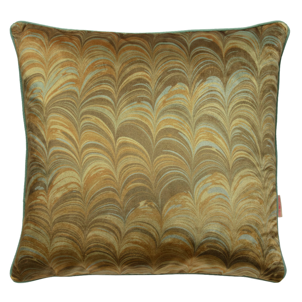Decorative pillow with a marbled pattern in mustard, pale blue and brown on a white background