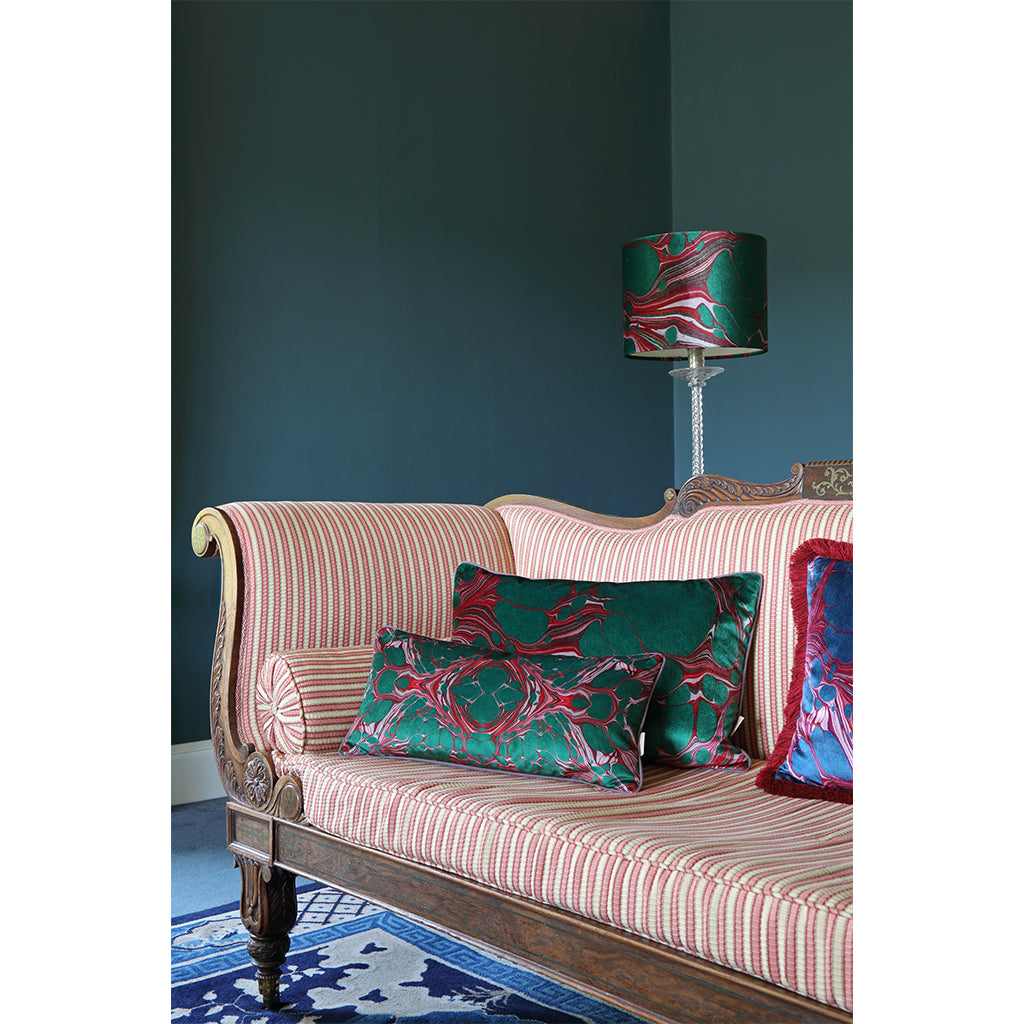 Green and pink velvet cushions on sofa with matching lamp shade
