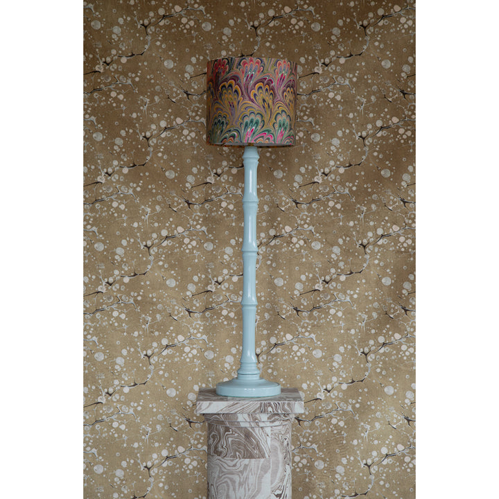 Decorative lamp with a patterned shade with a gold and brown marbled patterned fabric 