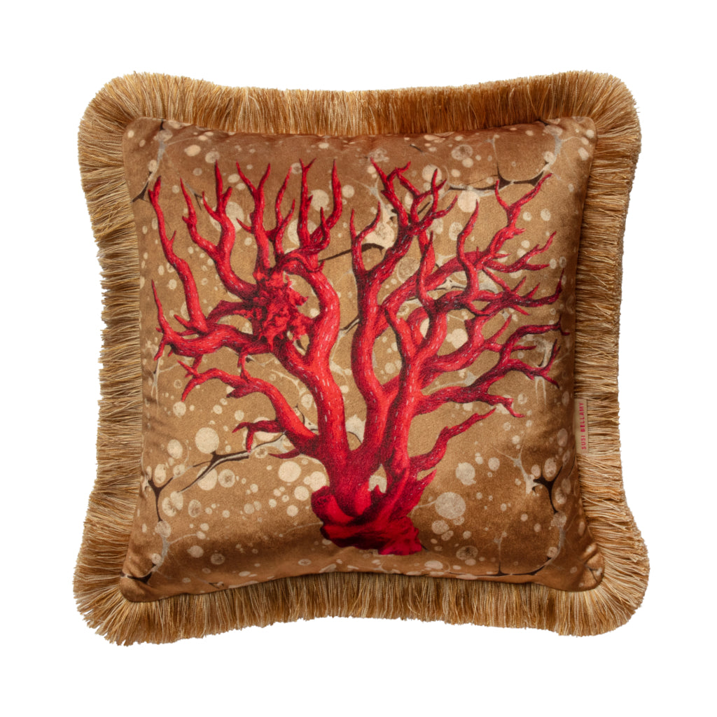 Decorative pillow with red coral design on a beige background