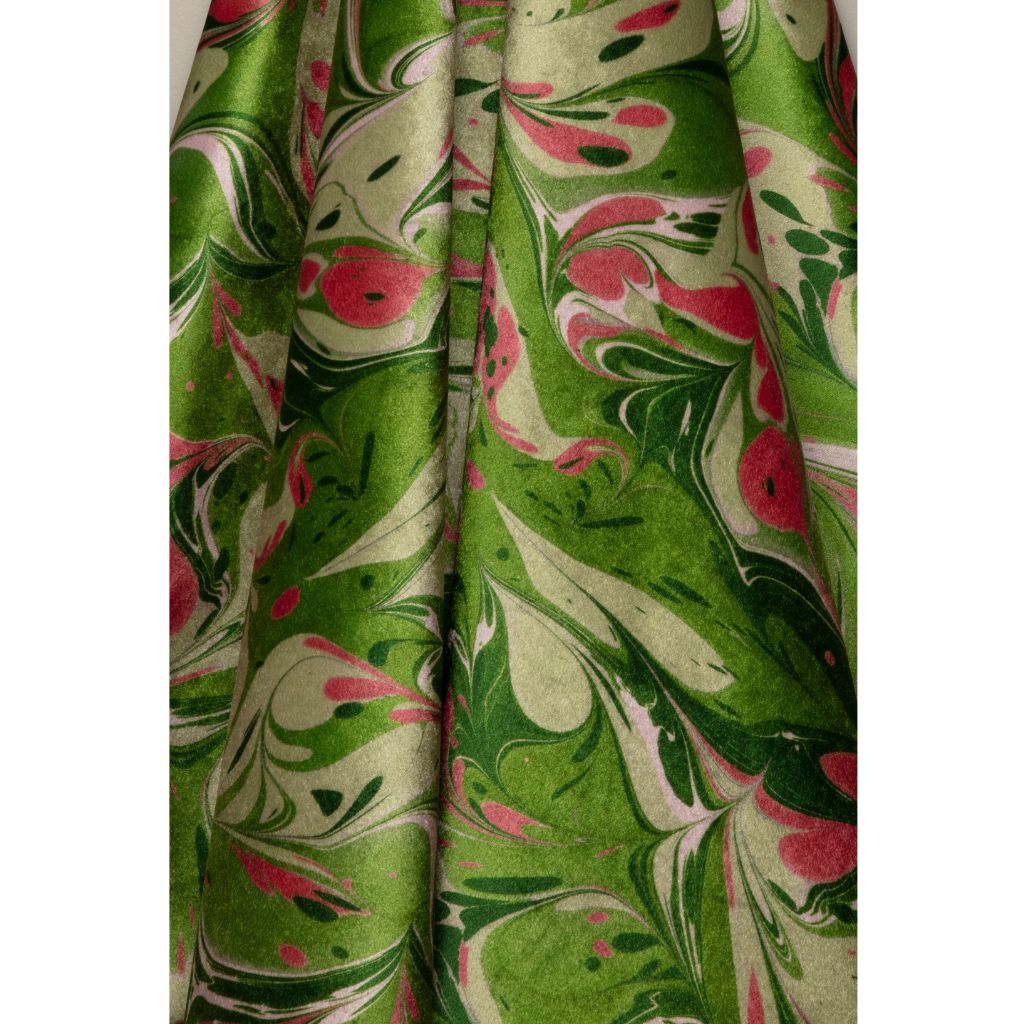 A close-up of draped fabric with a marbled pattern in olive green, cream, and pink, shown against a white background.
