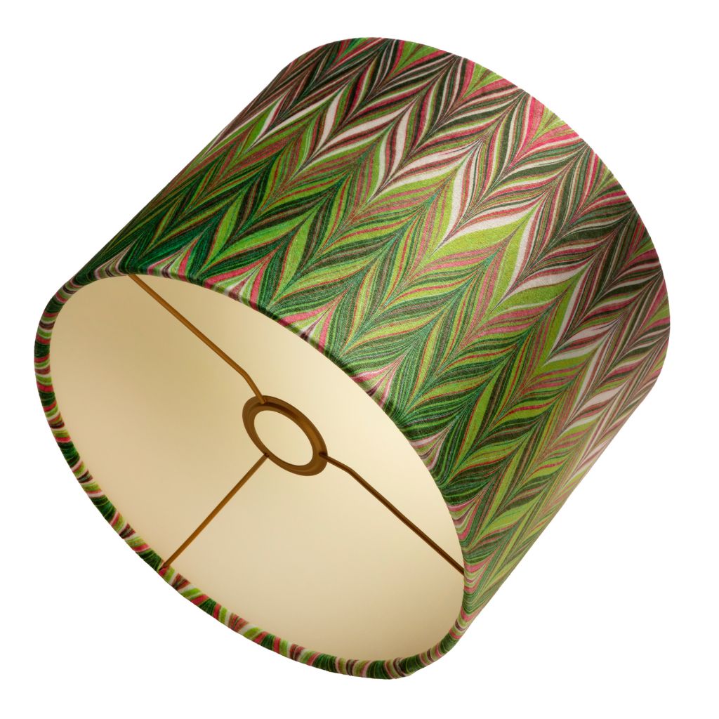 A drum lampshade with a vibrant green, pink, and beige chevron pattern on the exterior and a coloured interior.