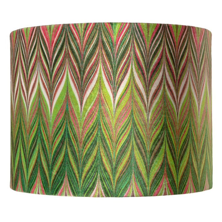 A cylindrical lampshade featuring a vibrant, repeating chevron pattern with vertical leaf-like stripes in green, pink, red, and cream.