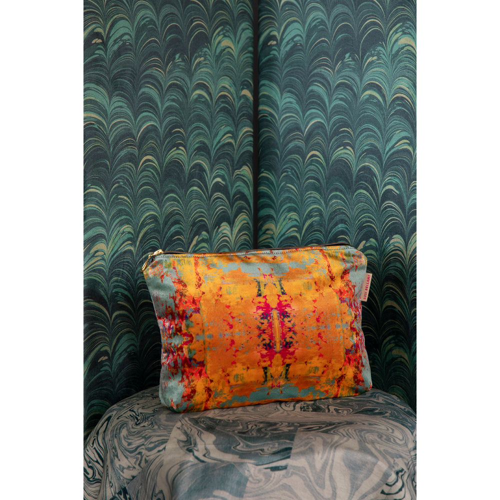 Colorful pouch on a patterned chair with green marbled wall in the background