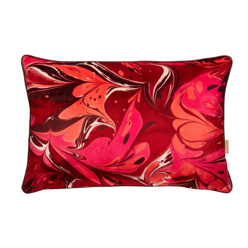 A rectangular lumbar throw pillow featuring a vibrant red, pink, and orange marbled abstract pattern on a solid white background.