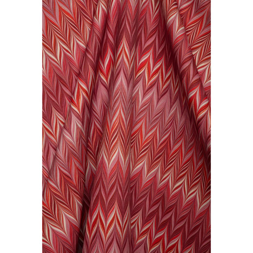 A close-up of draped fabric featuring a red, pink, and white chevron pattern.