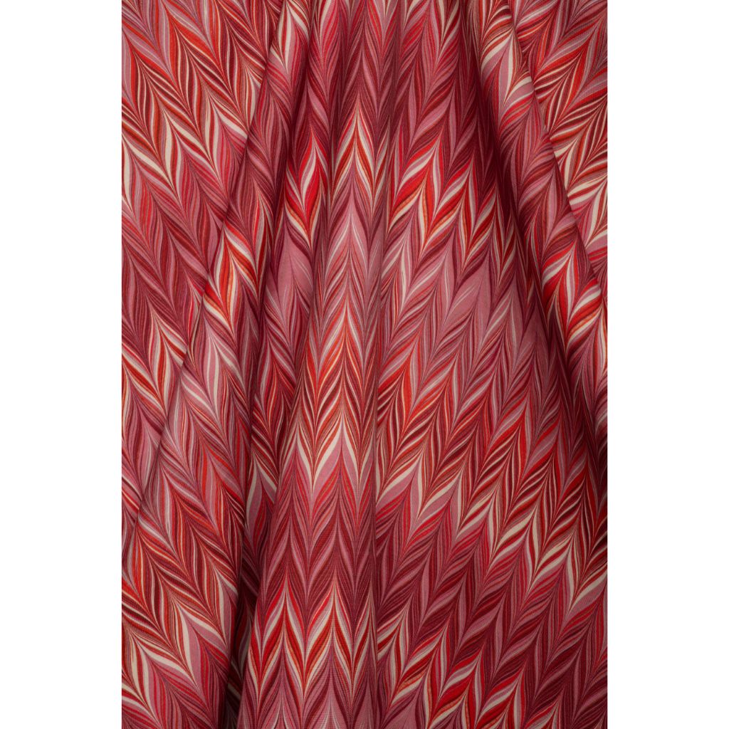 A close-up of draped fabric featuring a red, pink, and white chevron pattern.