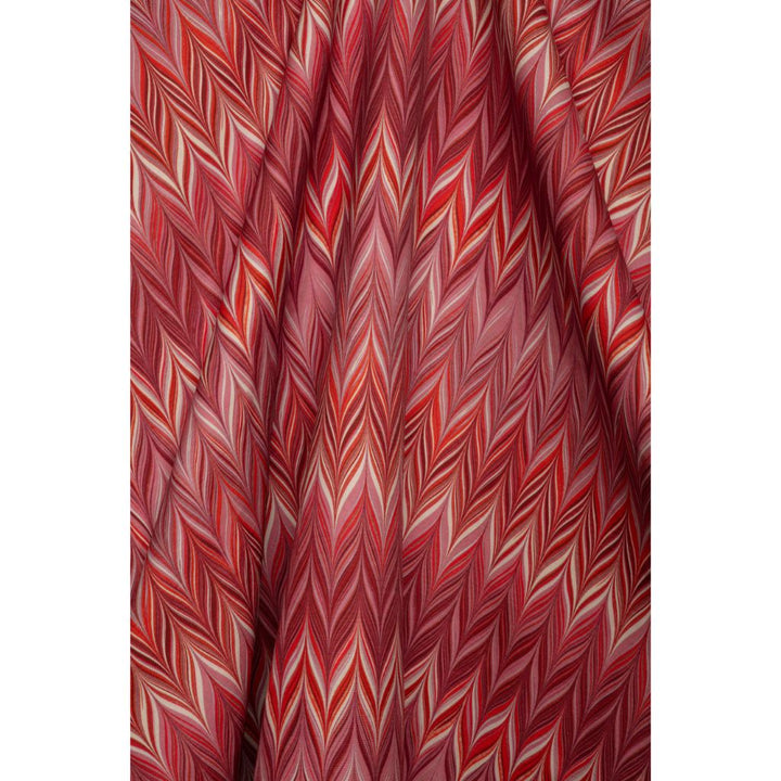 A close-up of draped fabric featuring a red, pink, and white chevron pattern.