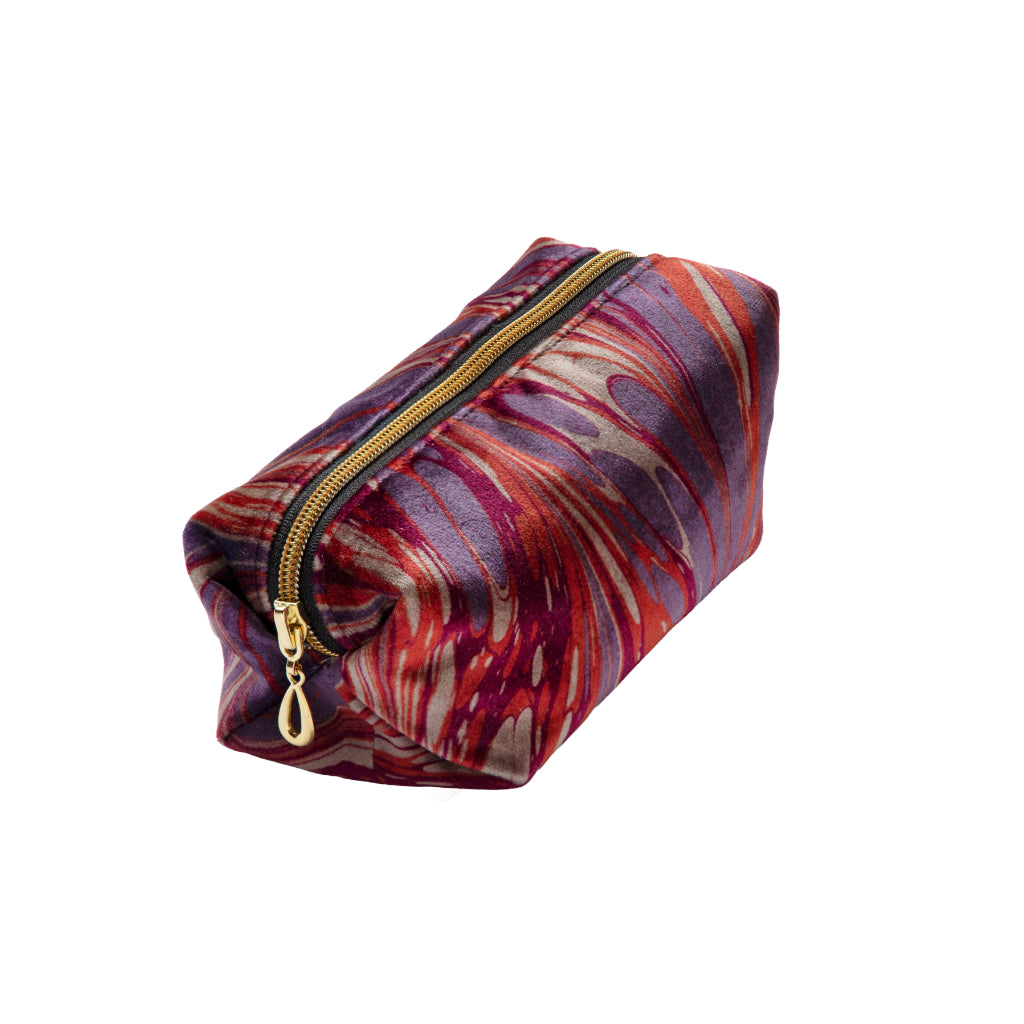 Marbled patterned pouch with a gold zipper on a white background