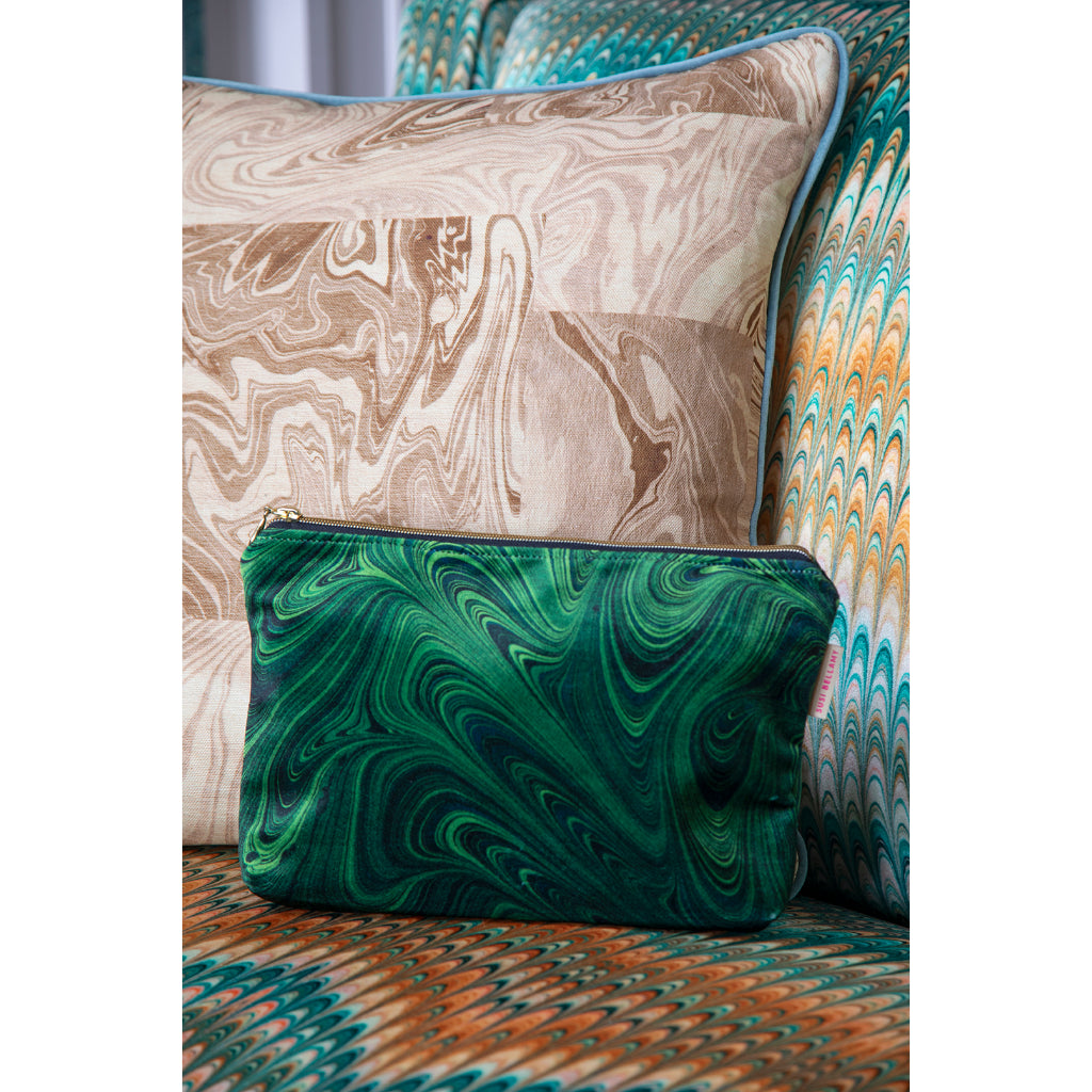 Green marbled velvet pouch on a patterned chair