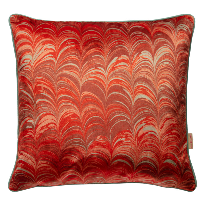 Decorative pillow with red and pale blue marbled pattern on a white background