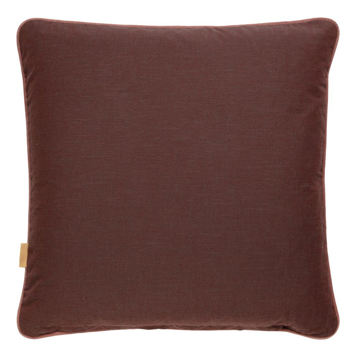 A square throw pillow in a rich dark brown fabric, photographed against a clean white background. A small beige fabric tag is visible on the lower left edge.