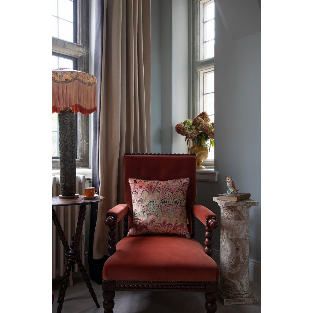 Decorative room with a red armchair, decorative pillow, and side table