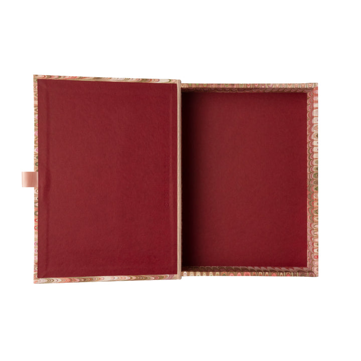 Marbled patterned pink box file on a white background