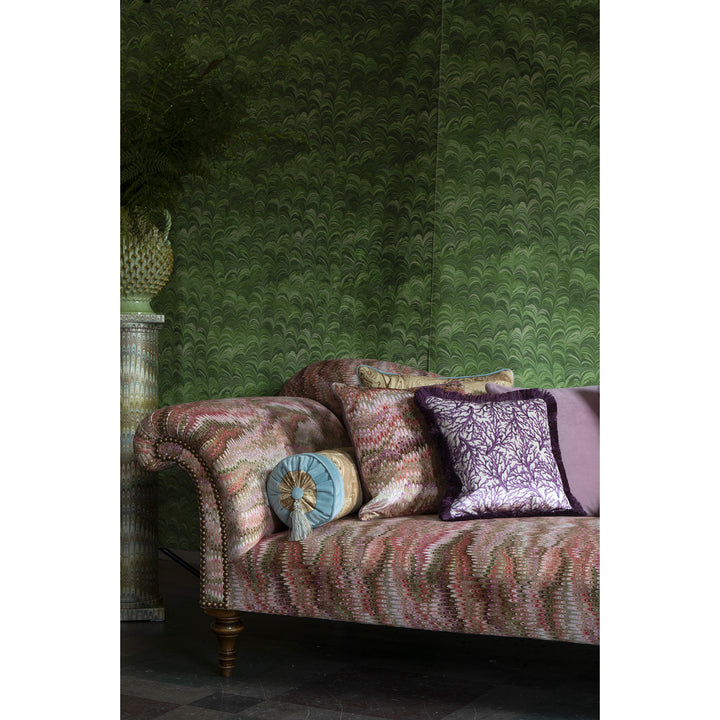 Marbled patterned sofa with cushions against a green marbled fabric wall
