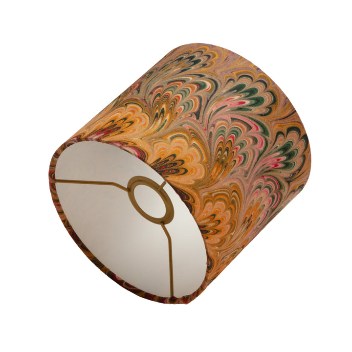 Marbled lampshade with a white interior and gold accent on a white background