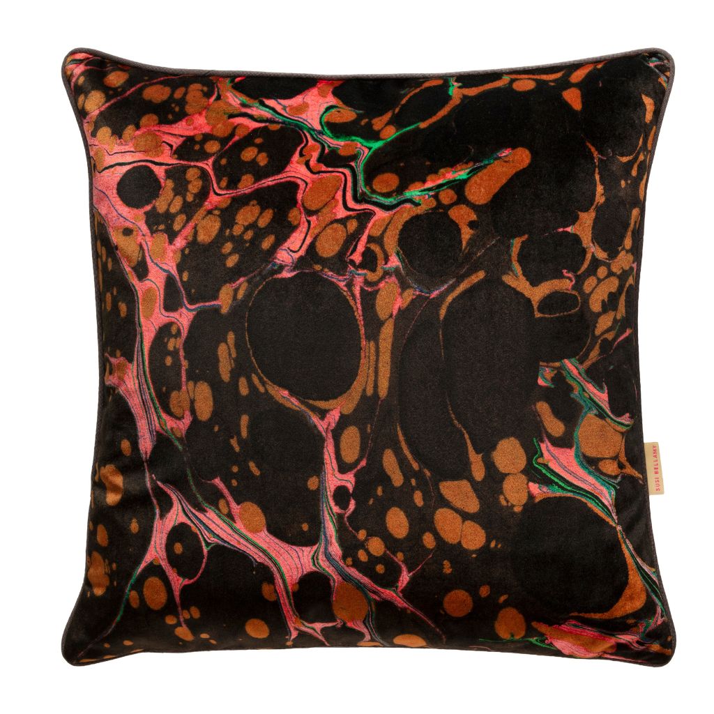A square throw pillow featuring a black background with an abstract marbled pattern in metallic copper, pink, and green, shown against a plain white background.