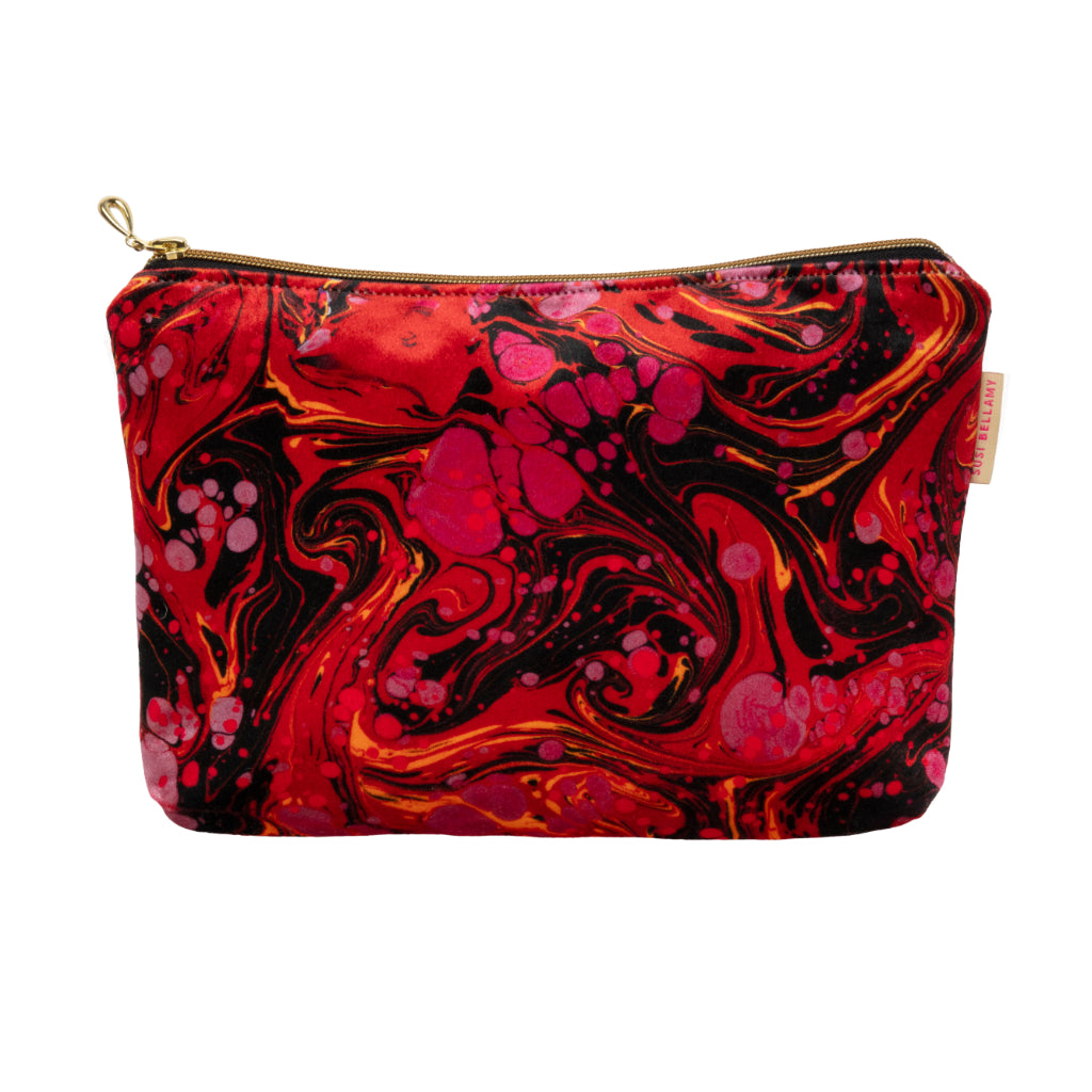 Marbled red, orange, and black pouch with gold zipper on a white background