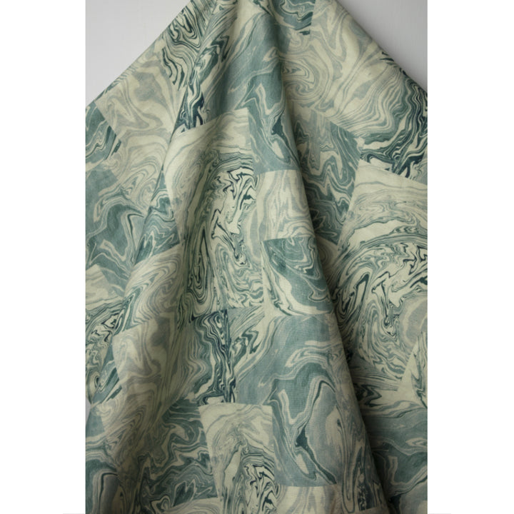 Patterned linen fabric with swirling design in shades of blue and white