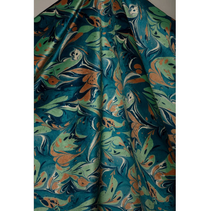 A draped piece of fabric featuring a marbled abstract pattern in teal, sage green, rust orange, and cream swirls.