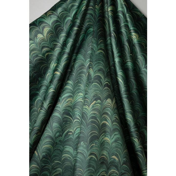 A close-up of draped fabric with a repeating marbleized pattern in dark green, teal, and muted gold tones.