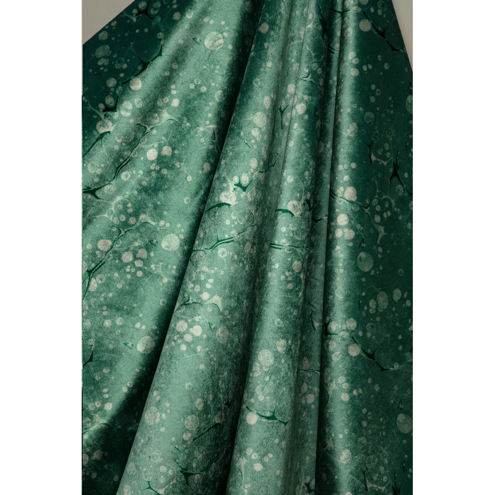 Green fabric with a subtle pattern on a plain background