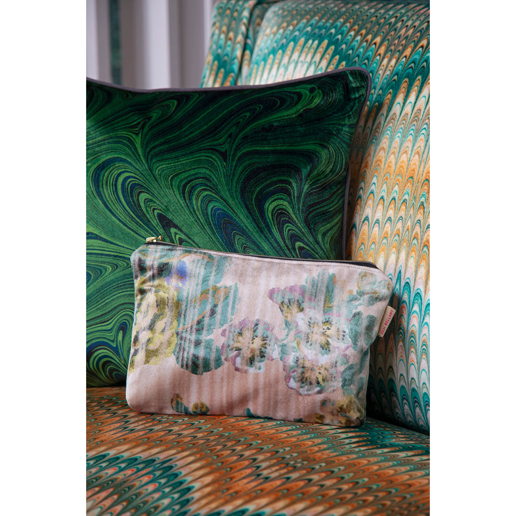 Floral patterned pouch on a decorative chair with green and orange abstract design