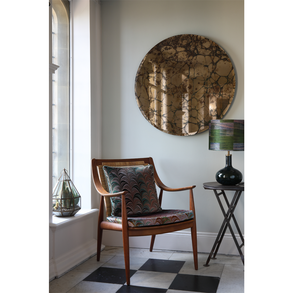 olive velvet cushion on checkerboard marble floor