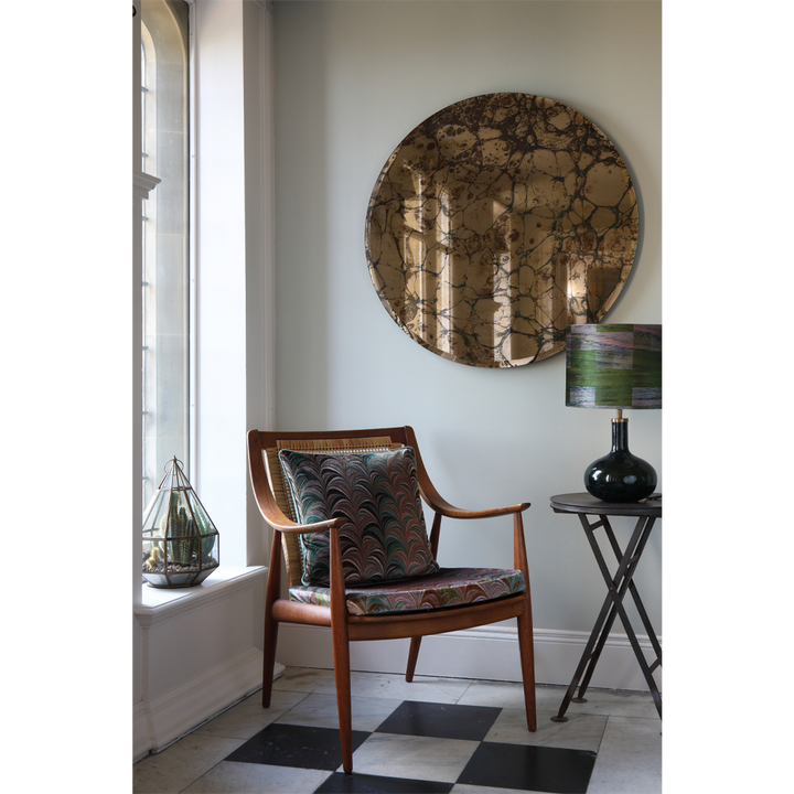 olive velvet cushion on checkerboard marble floor